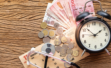 Selective focus stethoscope put on banknote, coin and calendar with copy space