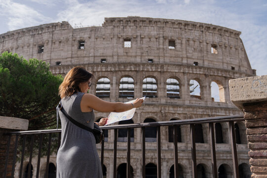 Female tourist reading map on attraction site