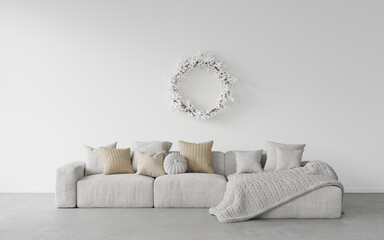White living room with a white sofa with pillows and a knitted blanket pigtail. on a concrete floor, a сhristmas wreath with snowberries on a white wall. Template, background for сhristmas  card
