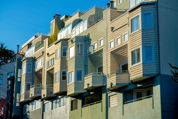 Row of apartment buildings with visible units for people who rent or buy house or homes in the downtown city neighborhoods