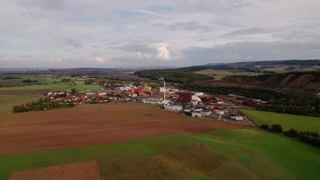 Aer ial view of a German village surrounded by meadows, farmland and forest in Germany.