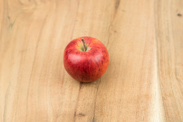 red fresh apples on a wooden surface