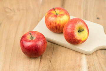 red fresh apples on a wooden surface