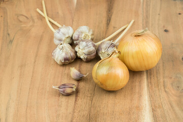 onion and garlic, composition on a wooden surface