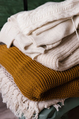 Stack of wool knitted sweaters.