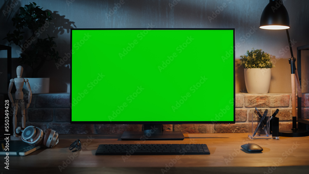 Leinwandbilder a modern personal computer monitor with chroma key green screen display standing on the desk of a co