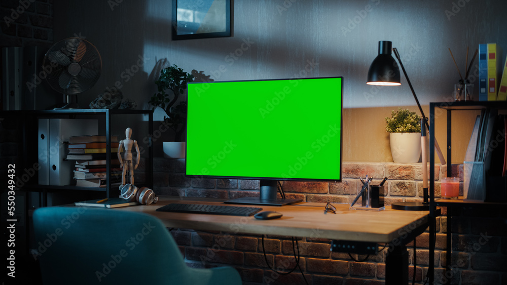 Fototapete a modern personal computer monitor with chroma key green screen display standing on the desk of a co