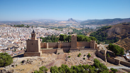 Aerial drone view of Antequera castle with the natural monument The Lovers' Rock in the background. Touristic travel to Spain. Historic interest and Unesco World Heritage Site. 