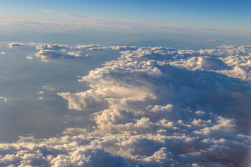 Photo taken from an airplane of the beautiful white clouds at the top of the atmosphere