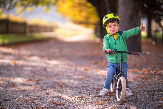 Boy with bicycle showing thumb up gesture