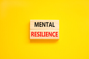 Mental resilience symbol. Concept word Mental resilience typed on wooden blocks. Beautiful yellow table yellow background. Business psychological and mental resilience concept. Copy space.