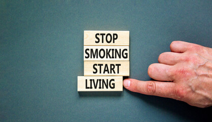 Stop smoking start living symbol. Concept words Stop smoking start living on cubes. Beautiful grey...