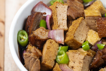 Tokwa't baboy is a typical Philippine appetizer or pulutan. It consists of pork ears, pork belly and deep-fried tofu, and is served in a mixture of soy sauce, pork broth, vinegar, chopped white onions