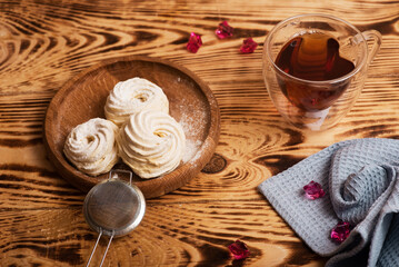 Handmade marshmallow. Natural sweetness. Apple zephir and cup of tea in wood surface