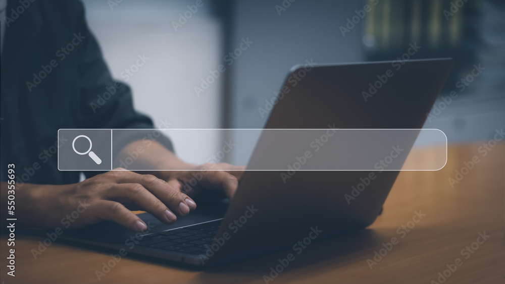 Aufkleber man's hand typing on a laptop computer that shows the search bar to find information on the web, sea