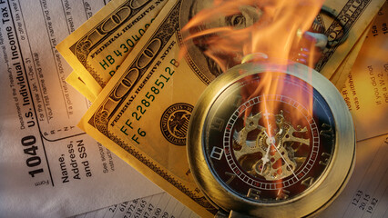 Burning pocket watch on financial papers as background