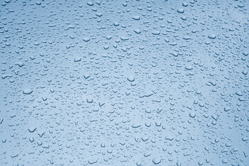 Close up rain drop on surface of car's body after passed from rainy area