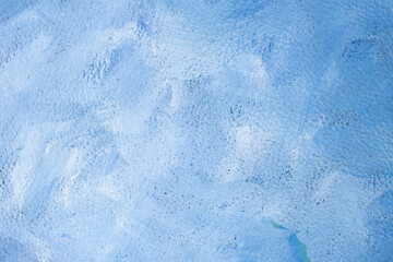 White and blue colors smudged on leather texture, abstract backdrop