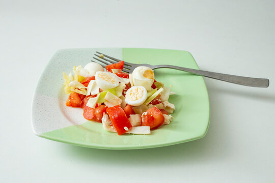 Quail Eggs Salad On A Green Plate, Side View