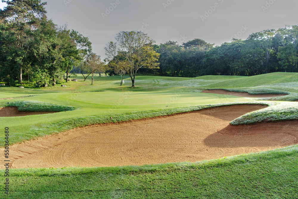 Wall mural sandpit bunker golf course backgrounds, the sandpit on the golf course fairway is used as a hurdle f