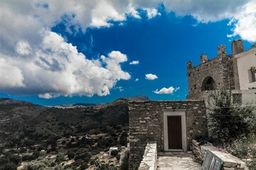 Beautiful cloudscape above the historical buildings and mountains. Greece.