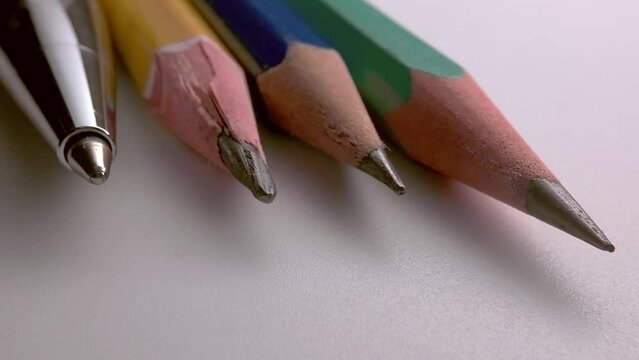 slate pencils and a pen on a white table. Desktop in the office.