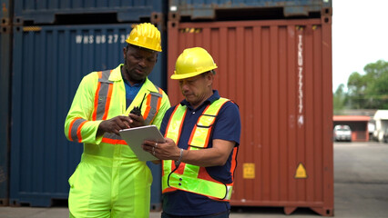 Logistic staff flying drone to survey and inspect stack container in shipment company area.