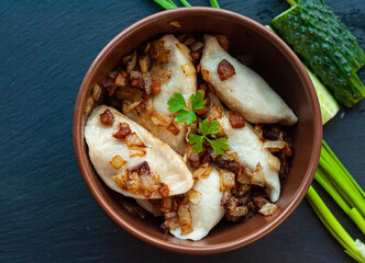 national Ukrainian dish, traditional varenyki with potatoes, cabbage, crackers made of lard and fried onions, food of the countries of the world, gastrotourism, culture of Ukraine