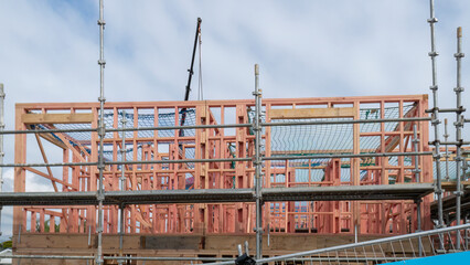 Residential houses under construction with metal scaffolding around them. Auckland.