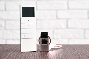 Remote wireless digital security controller and door keys on the table. Security and safety concepts