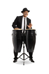 Cheerful mature man playing conga drums