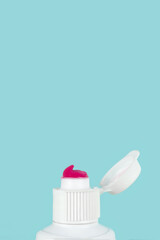 Toothpaste squeezed out from a toothpaste tube. Toothpaste dental care, Tooth paste close up on blue background.