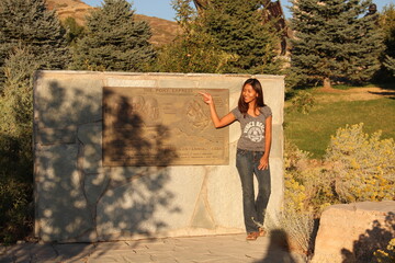 Woman standing at the historical landmark, Pony Express National Historic Trail, Salt Lake City, Utah