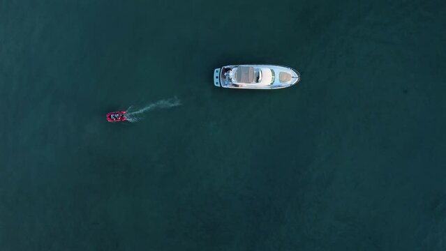4k Top view of ships move on waters outdoors irrl. Aerial view of different boats moving on turquoise surface and traveling in open air. Operator uses flying drone and captures amazing nature and