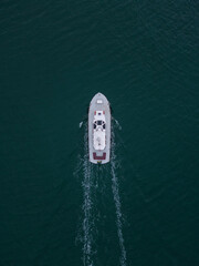 Aerial drone view of industrial tug assisting boat in deep sea