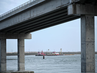 Tug boats on the Oregon Inlet near the new Herbert C Bonner bridge on the Outer Banks of North...