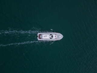 Aerial drone view of industrial tug assisting boat in deep sea