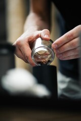 Vertical shot of a process of making an expresso coffee with hands and equipment