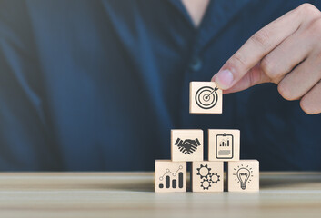 business strategy, Action plan, Goal and target, hand stack woods block step on table with icon about business strategy and Action plan. business development concept. copy space