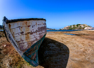 Old deserted traditional wooden fishing boat in Milos island, Cyclades, Greece