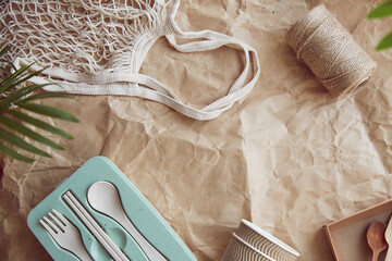 Zero waste, multiuse plastic free, ecological tableware. Eco shopping bag on crumpled paper....