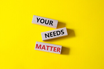 Your needs matter symbol. Wooden blocks with words Your needs matter. Beautiful yellow background. Business andYour needs matter concept. Copy space.