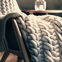 Chunky knit cream Hygge blanket throw over a modernist wooden chair