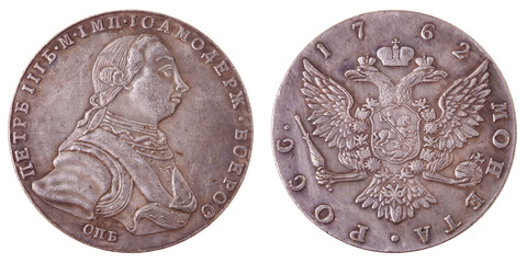A Russian silver coin with a value of 1 ruble in 1762. Two sides of the coin on a white background....