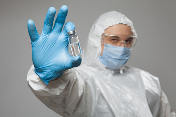 Closeup of vial to vaccinate in scientific virologist hand for immunization. Scientific virologist....