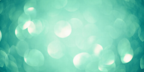 Green glitter background defocus light. Round defocuses on a blurred background.