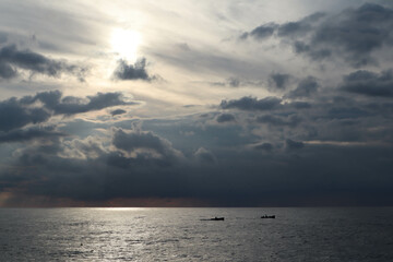 sunset over the sea with the sun and clouds