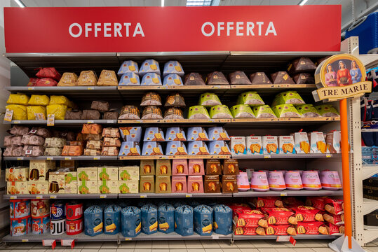 Bra, Cuneo, Italy - November 30, 2022: packs of panettone and pandoro of different fine Italian brands displayed in the offer shelf in an Italian supermarket. Tex: Offerta (offer)