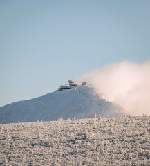 First snow on highest mountain in the Czech Republic - Snezka. Beautifull view at mountain with mysterious clouds.