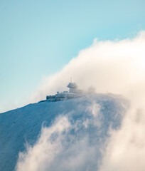 First snow on highest mountain in the Czech Republic - Snezka. Beautifull view at mountain with mysterious clouds.
